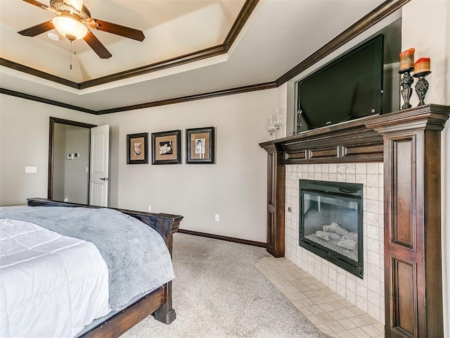15228 Turtle Lake Pl, Oklahoma City, OK 73165 - bedroom featuring light colored carpet, crown molding, a fireplace, a tray ceiling, and a ceiling fan