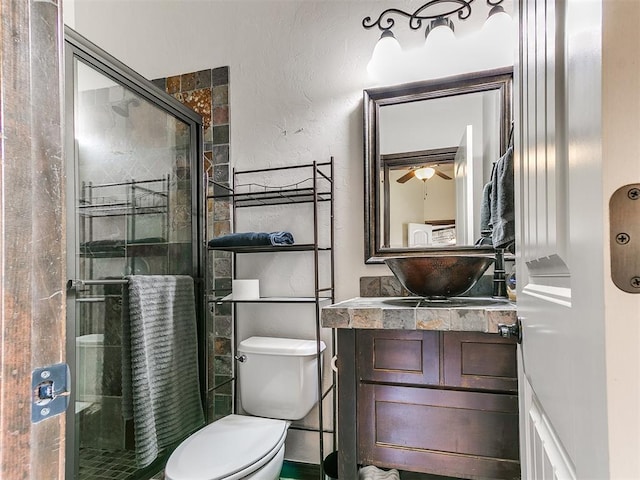 15228 Turtle Lake Pl, Oklahoma City, OK 73165 - full bathroom with toilet, vanity, a stall shower, ceiling fan, and a textured wall