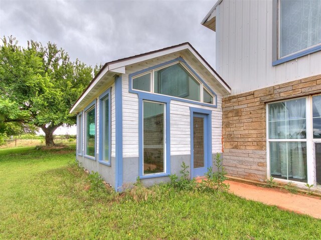 4355 S Midwest Blvd, Guthrie, OK 73044 - view of side of property with a lawn and stone siding