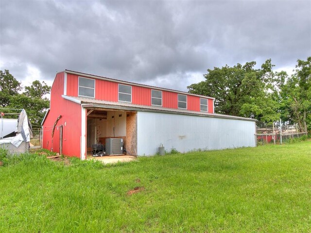 4355 S Midwest Blvd, Guthrie, OK 73044 - rear view of property featuring a pole building, a lawn, an outbuilding, and central AC