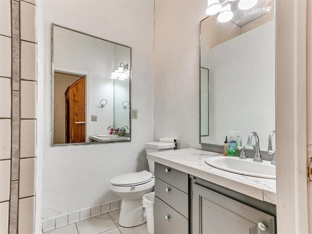 4355 S Midwest Blvd, Guthrie, OK 73044 - bathroom with toilet, vanity, and tile patterned floors