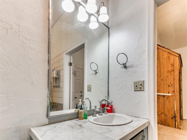 4355 S Midwest Blvd, Guthrie, OK 73044 - bathroom featuring vanity, a chandelier, and a textured wall