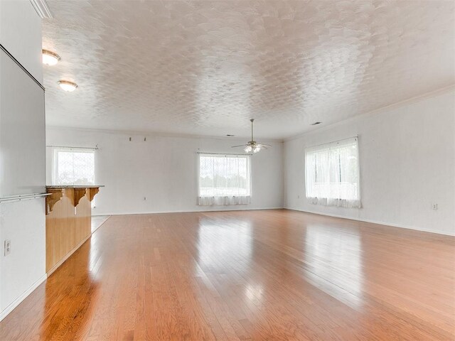 4355 S Midwest Blvd, Guthrie, OK 73044 - unfurnished living room with a ceiling fan and light wood-style flooring