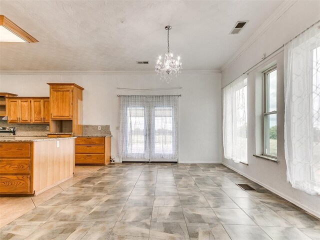4355 S Midwest Blvd, Guthrie, OK 73044 - kitchen with decorative backsplash, a chandelier, brown cabinets, pendant lighting, and open shelves