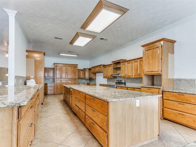 4355 S Midwest Blvd, Guthrie, OK 73044 - kitchen with stainless steel electric range oven, light tile patterned floors, tasteful backsplash, crown molding, and a textured ceiling