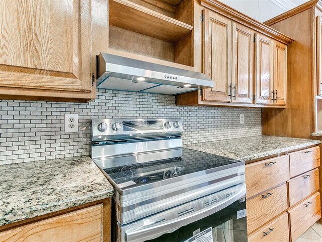 4355 S Midwest Blvd, Guthrie, OK 73044 - kitchen with stainless steel electric range oven, range hood, backsplash, light stone countertops, and open shelves