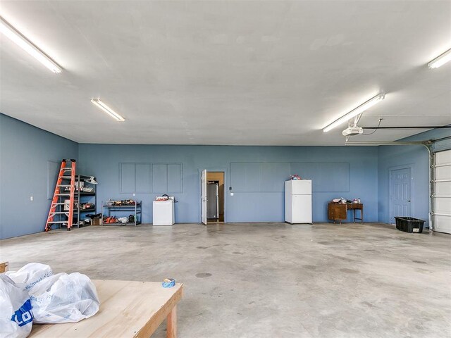 4355 S Midwest Blvd, Guthrie, OK 73044 - garage featuring freestanding refrigerator and a garage door opener