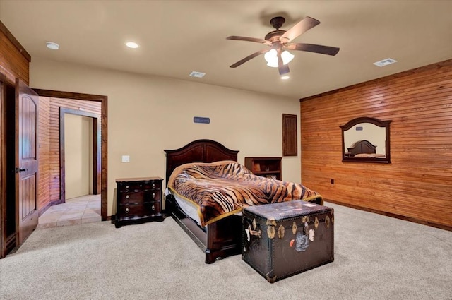 2801 John Deere Ave Unit 1, Edmond, OK 73034 - bedroom with wooden walls, light carpet, recessed lighting, a ceiling fan, and an accent wall