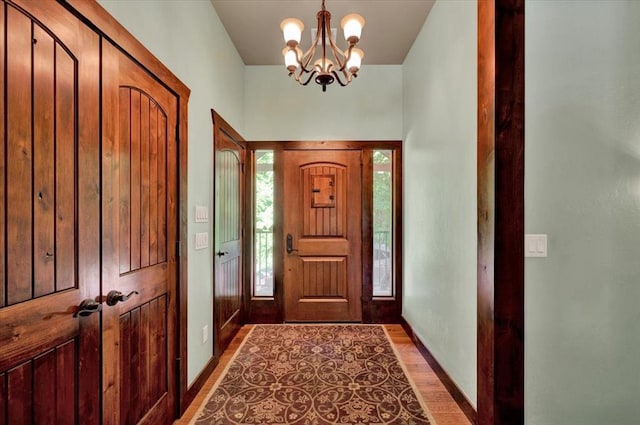 2801 John Deere Ave Unit 1, Edmond, OK 73034 - foyer with a chandelier, light wood-style flooring, and baseboards