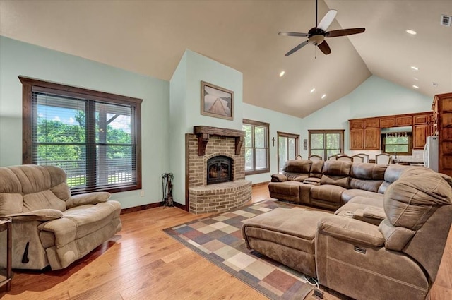 2801 John Deere Ave Unit 1, Edmond, OK 73034 - living area with ceiling fan, a fireplace, light wood finished floors, high vaulted ceiling, and healthy amount of natural light