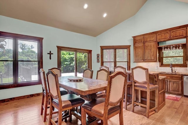 2801 John Deere Ave Unit 1, Edmond, OK 73034 - dining area featuring light wood finished floors, high vaulted ceiling, and recessed lighting