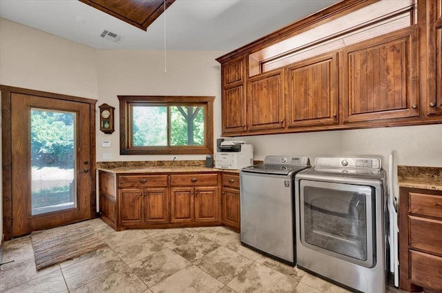 2801 John Deere Ave Unit 1, Edmond, OK 73034 - laundry area with cabinet space, washer and clothes dryer, and attic access