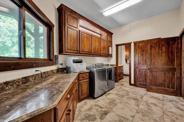 2801 John Deere Ave Unit 1, Edmond, OK 73034 - laundry room featuring independent washer and dryer, cabinet space, and healthy amount of natural light