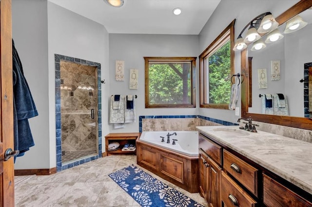 2801 John Deere Ave Unit 1, Edmond, OK 73034 - bathroom featuring a jetted tub, a shower stall, vanity, and baseboards
