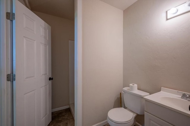 2801 John Deere Ave Unit 1, Edmond, OK 73034 - bathroom with vanity, toilet, and baseboards