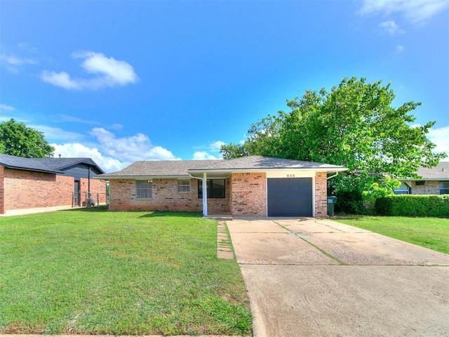 808 Robin Hill Rd, Edmond, OK 73003 - ranch-style home with a garage, a front lawn, brick siding, and concrete driveway