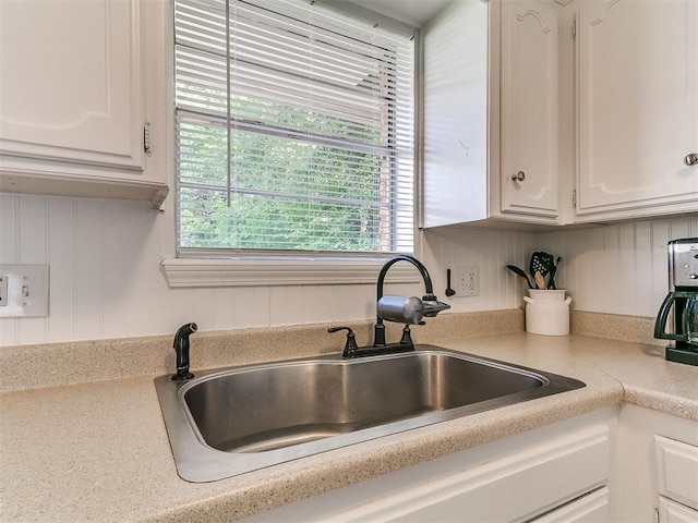808 Robin Hill Rd, Edmond, OK 73003 - kitchen with a sink, white cabinetry, and light countertops