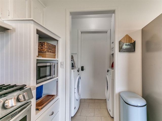 808 Robin Hill Rd, Edmond, OK 73003 - laundry room featuring washer / dryer and light tile patterned floors
