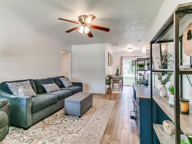 808 Robin Hill Rd, Edmond, OK 73003 - living area with a textured ceiling, a ceiling fan, wood finished floors, and baseboards