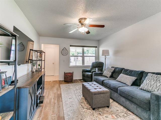 808 Robin Hill Rd, Edmond, OK 73003 - living room featuring a textured ceiling, ceiling fan, and light wood-style floors