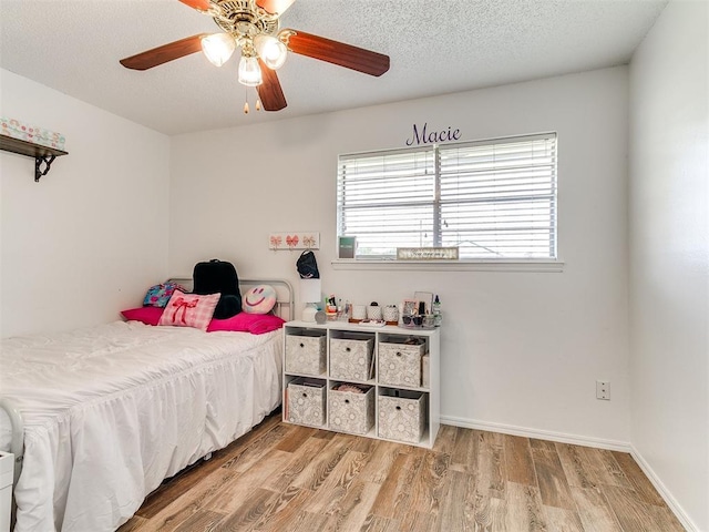 808 Robin Hill Rd, Edmond, OK 73003 - bedroom featuring wood finished floors, multiple windows, ceiling fan, and baseboards
