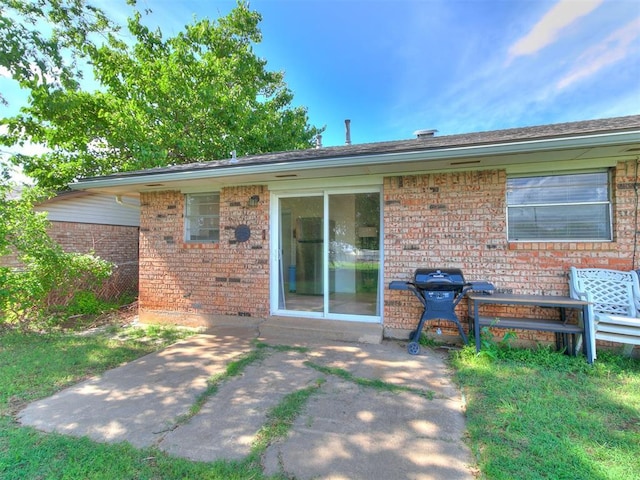 808 Robin Hill Rd, Edmond, OK 73003 - back of house featuring brick siding and a patio area