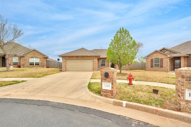 11240 NW 106th St, Yukon, OK 73099 - view of front of house featuring concrete driveway, a garage, and brick siding