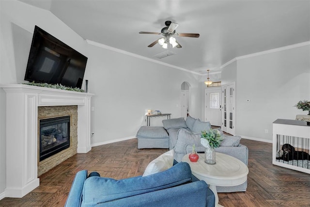 11240 NW 106th St, Yukon, OK 73099 - living area with a glass covered fireplace, a ceiling fan, ornamental molding, arched walkways, and baseboards