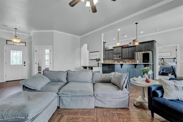 11240 NW 106th St, Yukon, OK 73099 - living area with ceiling fan, crown molding, arched walkways, and recessed lighting