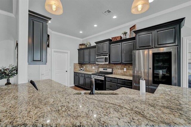 11240 NW 106th St, Yukon, OK 73099 - kitchen featuring stainless steel appliances, light stone counters, tasteful backsplash, a sink, and recessed lighting