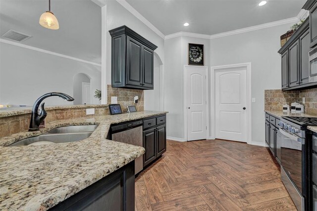 11240 NW 106th St, Yukon, OK 73099 - kitchen featuring a sink, arched walkways, stainless steel appliances, recessed lighting, and light stone counters