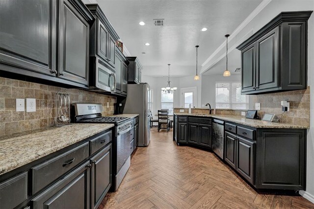 11240 NW 106th St, Yukon, OK 73099 - kitchen with appliances with stainless steel finishes, a chandelier, a peninsula, decorative light fixtures, and recessed lighting