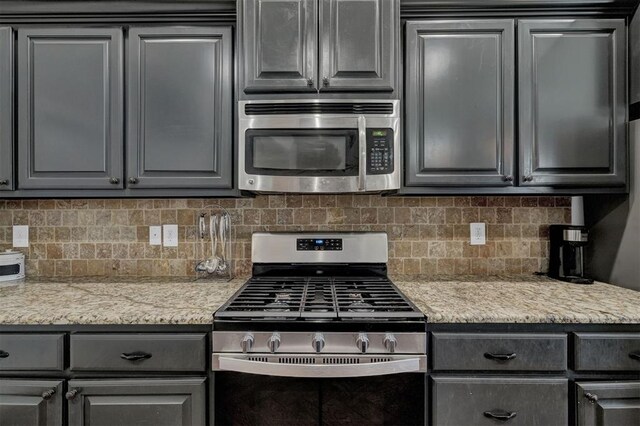 11240 NW 106th St, Yukon, OK 73099 - kitchen featuring stainless steel appliances, tasteful backsplash, and gray cabinets