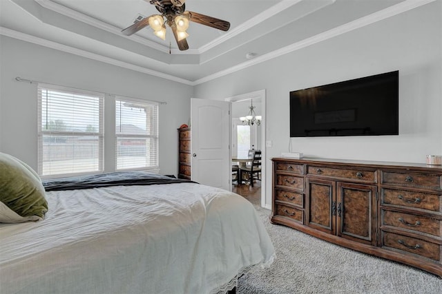 11240 NW 106th St, Yukon, OK 73099 - bedroom with a raised ceiling, ornamental molding, light colored carpet, a chandelier, and a ceiling fan