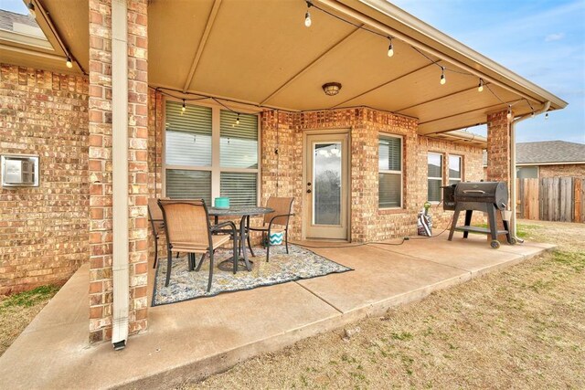 11240 NW 106th St, Yukon, OK 73099 - view of patio with a grill and outdoor dining area