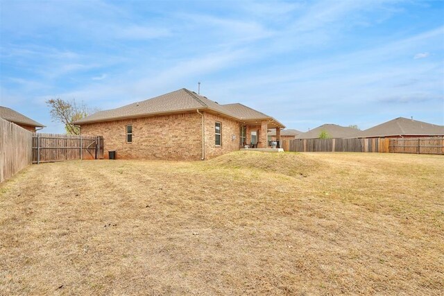 11240 NW 106th St, Yukon, OK 73099 - back of house with brick siding and a shingled roof