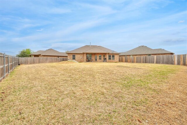 11240 NW 106th St, Yukon, OK 73099 - rear view of property featuring brick siding