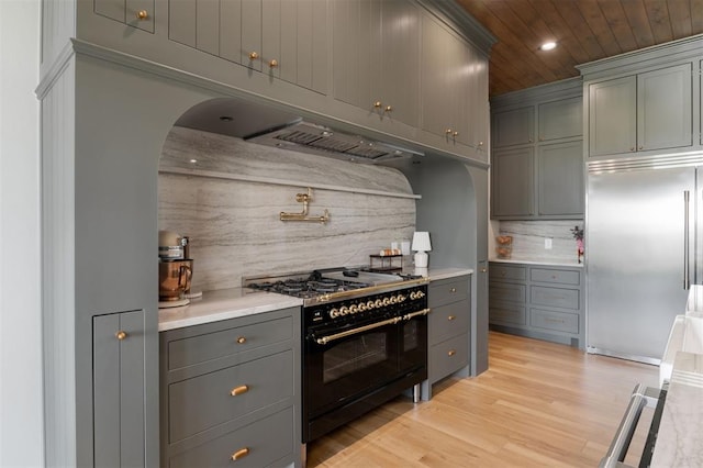 16000 N Hogback Rd, Luther, OK 73054 - kitchen featuring built in refrigerator, double oven range, arched walkways, gray cabinetry, and wooden ceiling