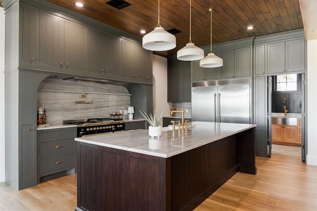 16000 N Hogback Rd, Luther, OK 73054 - kitchen featuring high quality appliances, wood ceiling, backsplash, light wood-style flooring, and light stone countertops