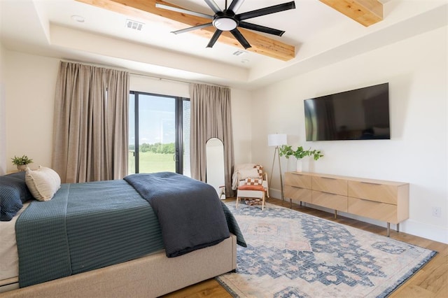 16000 N Hogback Rd, Luther, OK 73054 - bedroom with a raised ceiling, wood finished floors, access to outside, and ceiling fan