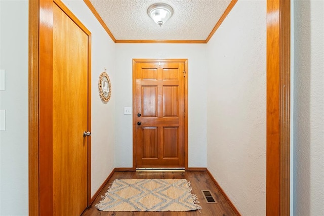 2016 Castle Rock, Edmond, OK 73003 - entryway with wood finished floors, a textured ceiling, crown molding, and baseboards