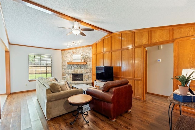 2016 Castle Rock, Edmond, OK 73003 - living area with wood finished floors, a textured ceiling, a stone fireplace, ceiling fan, and ornamental molding