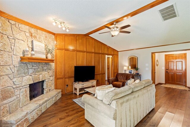 2016 Castle Rock, Edmond, OK 73003 - living area with a fireplace, a ceiling fan, ornamental molding, wood finished floors, and a textured ceiling