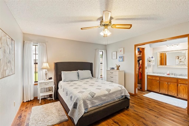 2016 Castle Rock, Edmond, OK 73003 - bedroom featuring a textured ceiling, wood finished floors, ceiling fan, and baseboards
