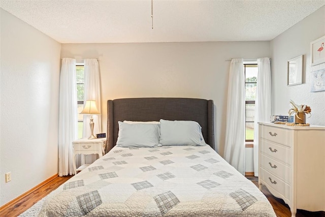 2016 Castle Rock, Edmond, OK 73003 - bedroom with dark wood-style flooring and a textured ceiling