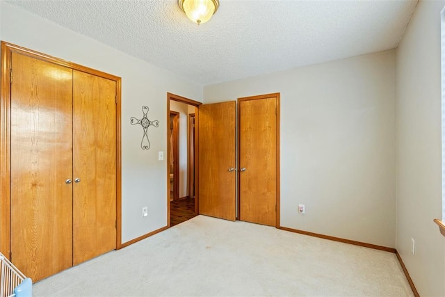 2016 Castle Rock, Edmond, OK 73003 - carpeted bedroom with a closet, baseboards, and a textured ceiling