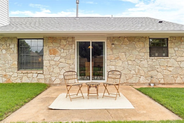2016 Castle Rock, Edmond, OK 73003 - view of exterior entry with stone siding, a patio area, and roof with shingles