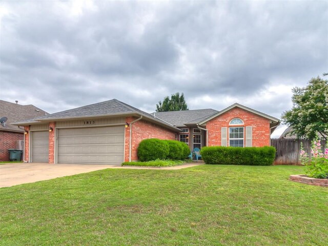 1813 Richard Dr, Edmond, OK 73003 - ranch-style home featuring brick siding, a garage, driveway, and roof with shingles