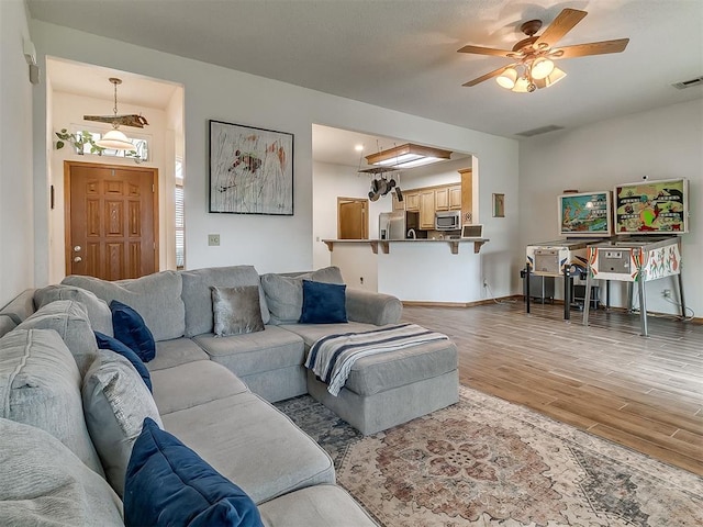 1813 Richard Dr, Edmond, OK 73003 - living room with light wood-type flooring, a ceiling fan, and baseboards