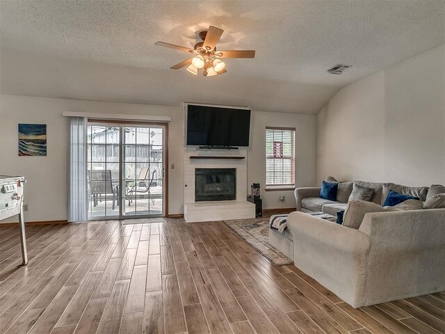 1813 Richard Dr, Edmond, OK 73003 - living area with wood finished floors, ceiling fan, a textured ceiling, baseboards, and vaulted ceiling